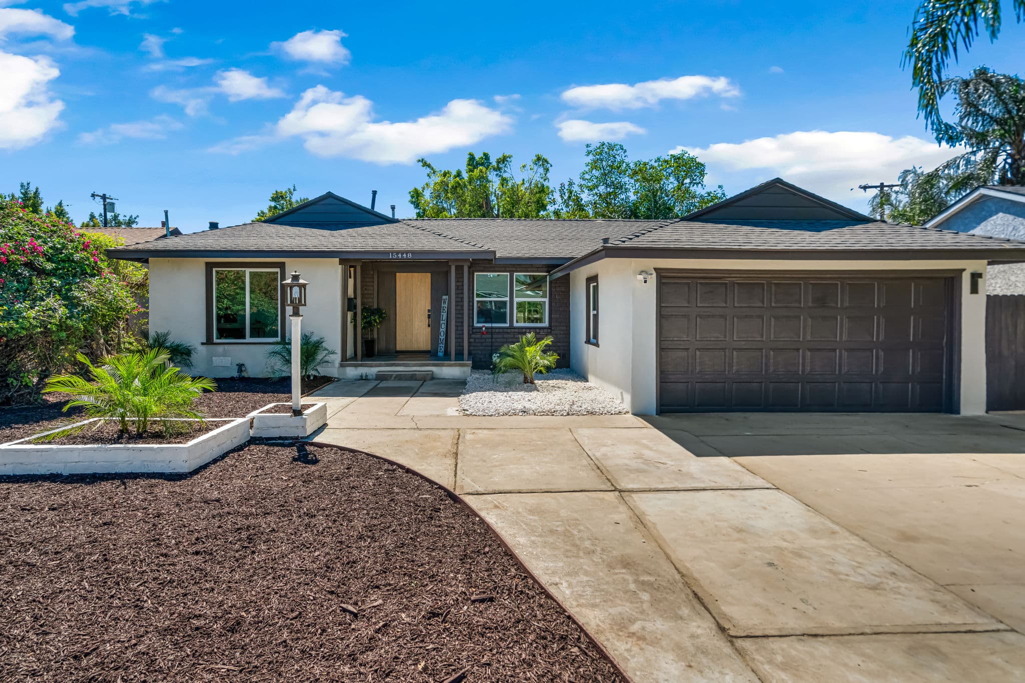 15448 Stare St, Mission Hills, CA 91345 — beautifully renovated single-family home with tropical landscaping and dark trim exterior