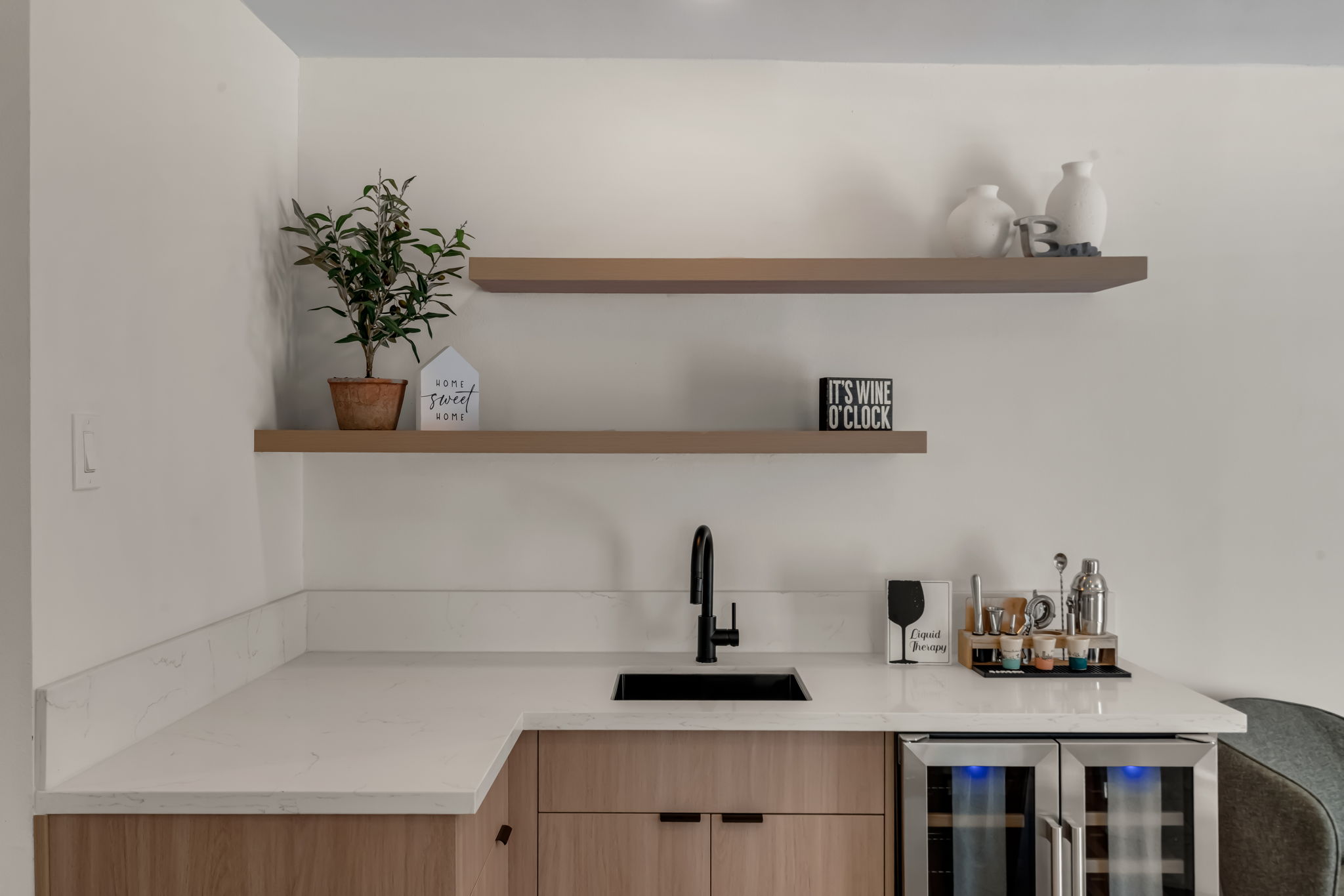 Built-in bar with wine fridge and floating shelves